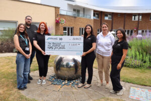 The FAAC Entrance Solutions team visit Shooting Star House to present their fundraising total.